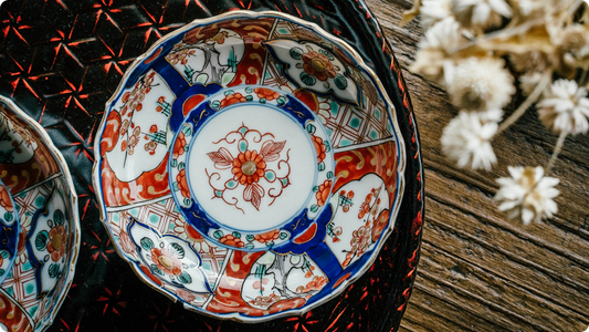 Somenishiki rim plate with red and green overglaze enamel layered over cobalt sometsuke, a red floral medallion at its center