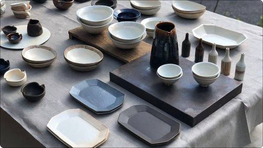 Furutani Pottery kohiki pieces laid out on linen: octagonal plates, rinka bowls, rice bowls and a katakuchi